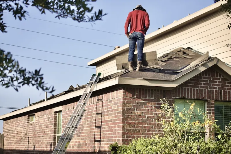 Professional roofer working on a residential roof in Blue Springs